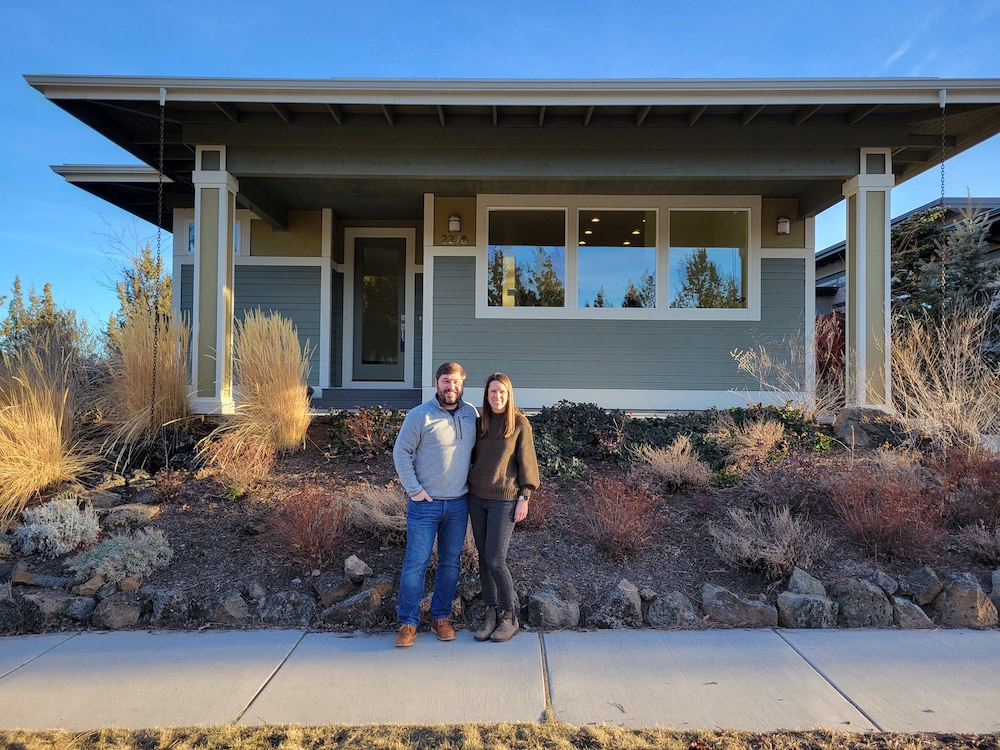 couple in front of house with xeriscape yard