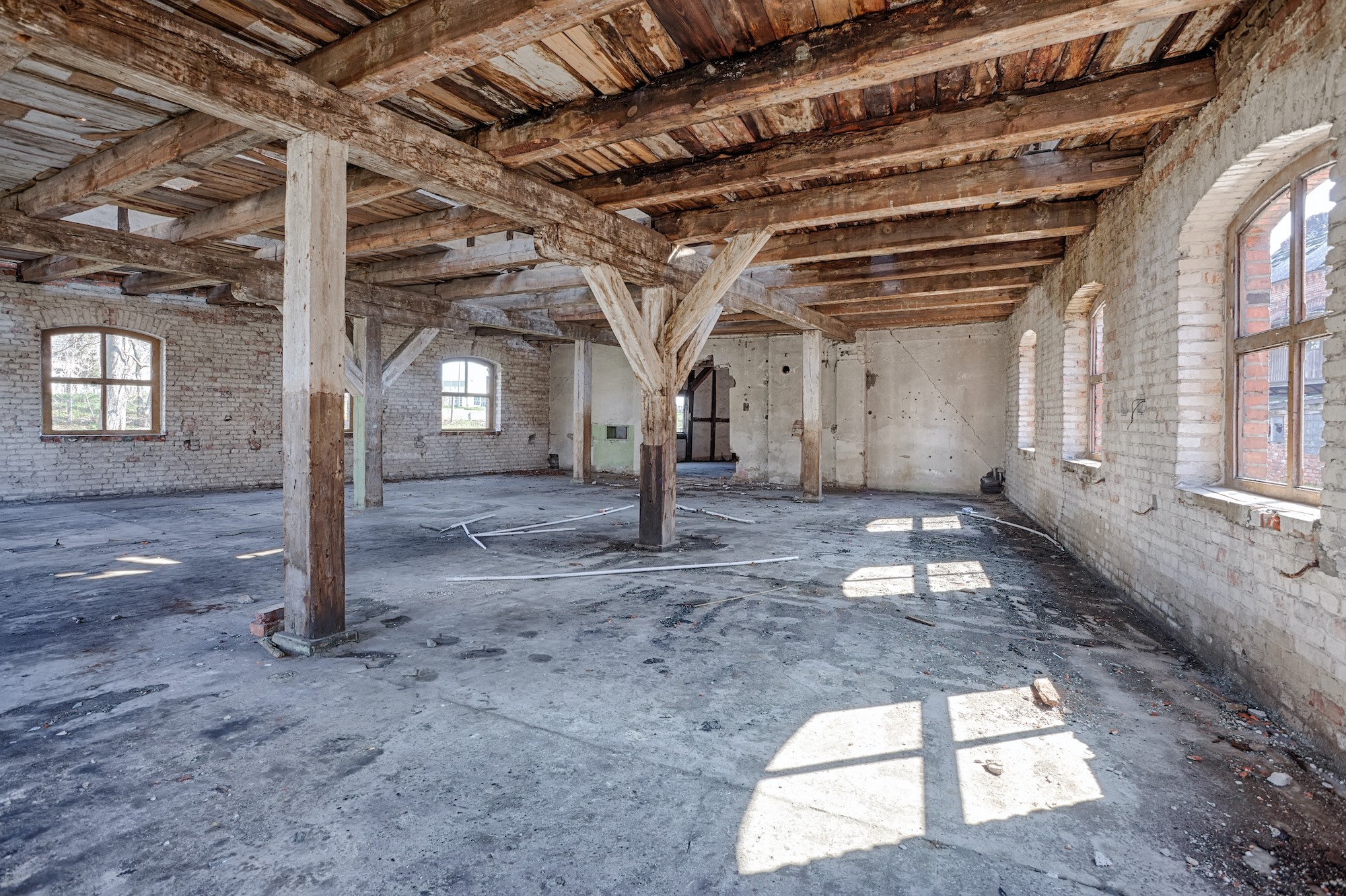interior of old commercial building with wood beams Old, abandoned and forgotten building