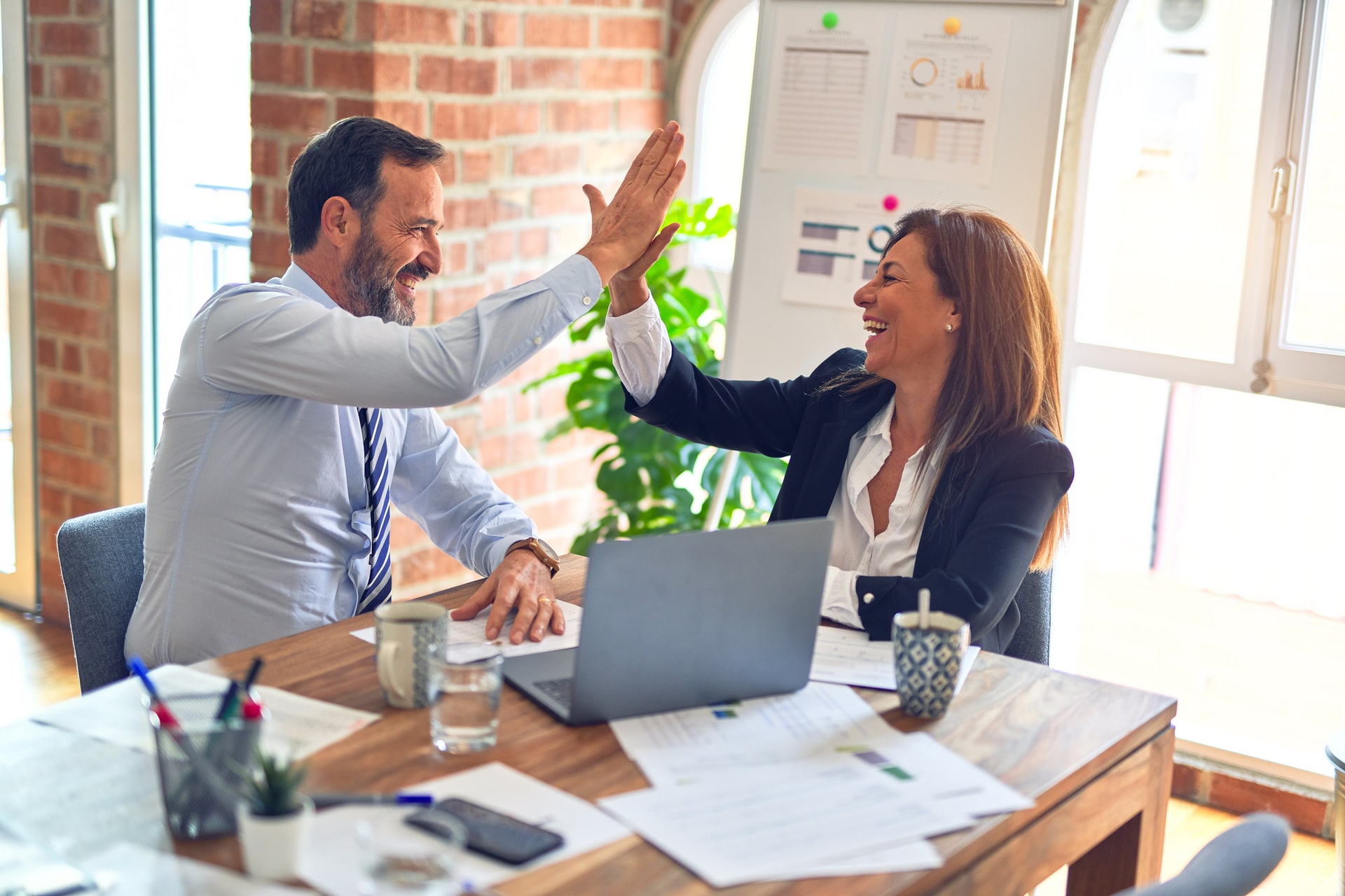 woman and man high five krakenimages-376KN_ISplE-unsplash