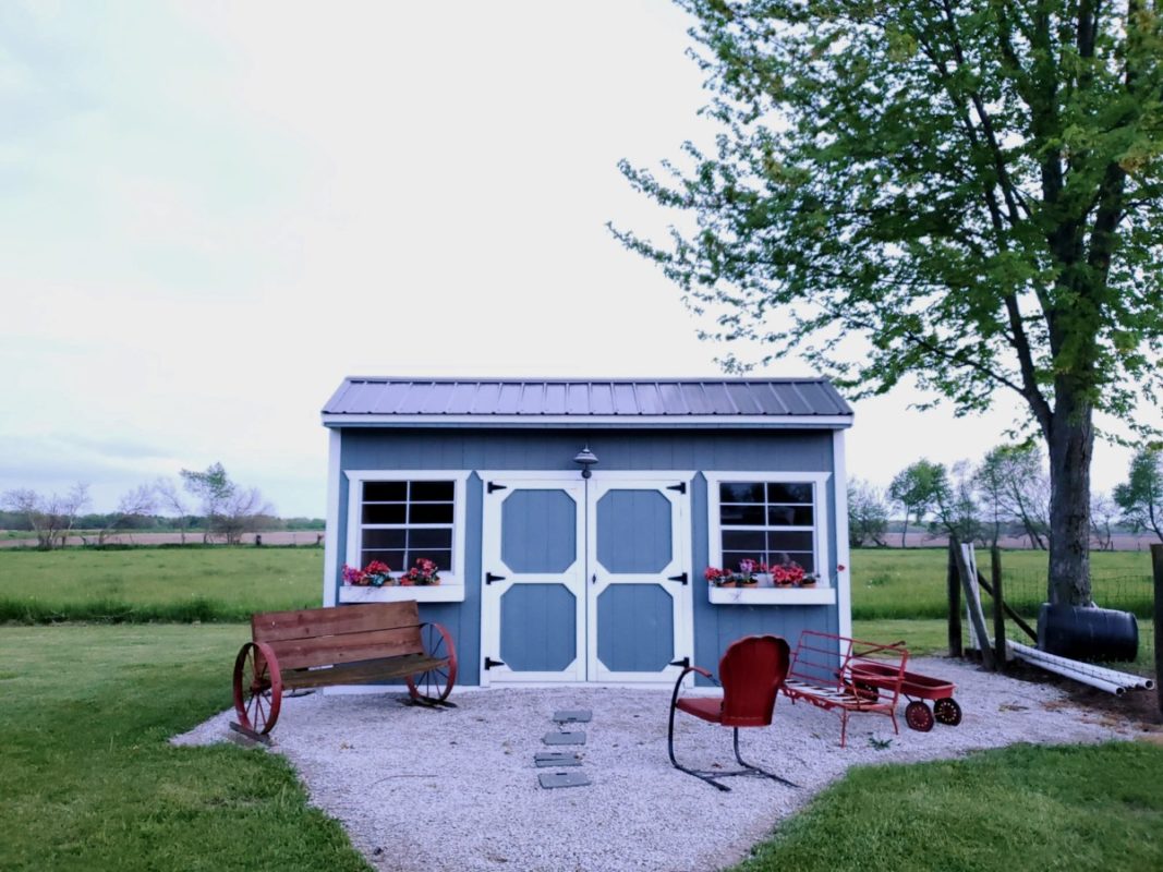 small blue building as an adu or shed