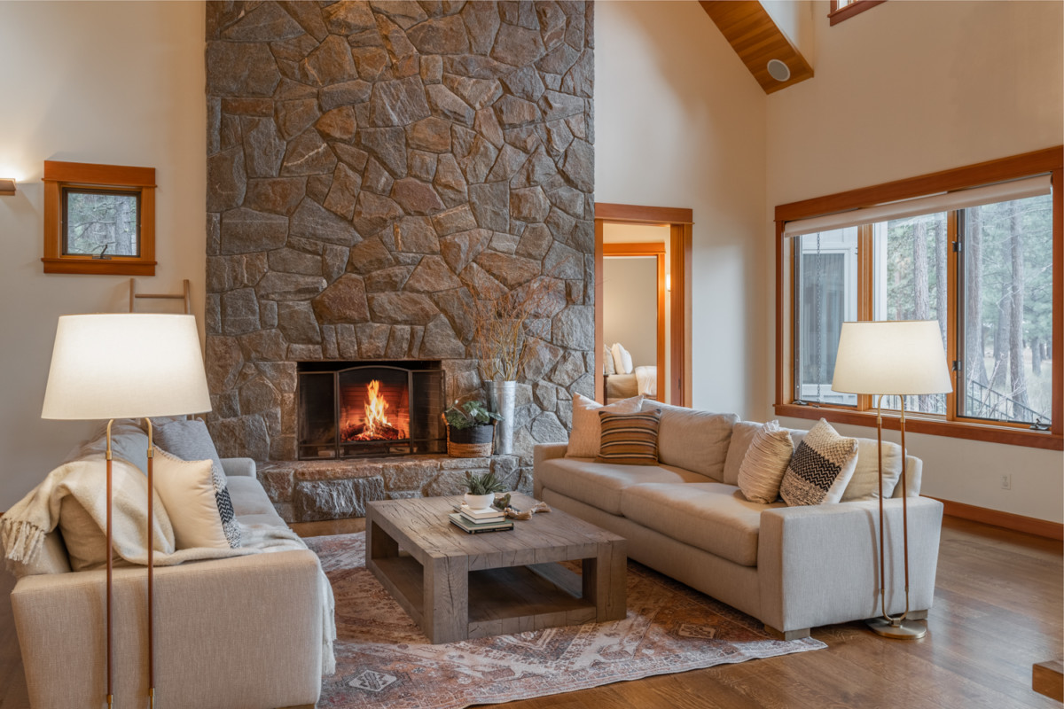 living room with large stone fireplace