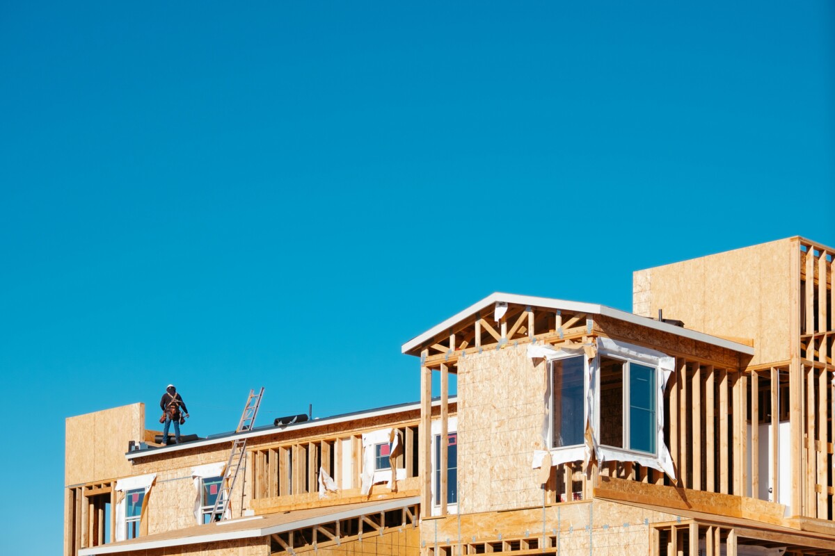 home under construction under a clear, blue sky