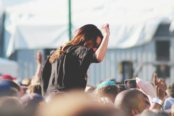 woman on top of crowd at outside event